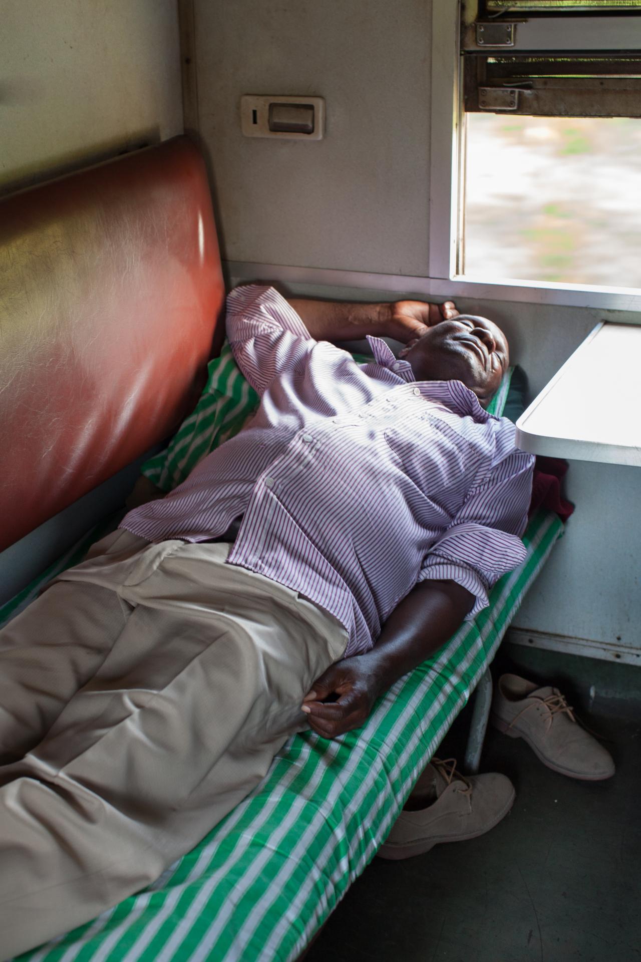 man asleep in train