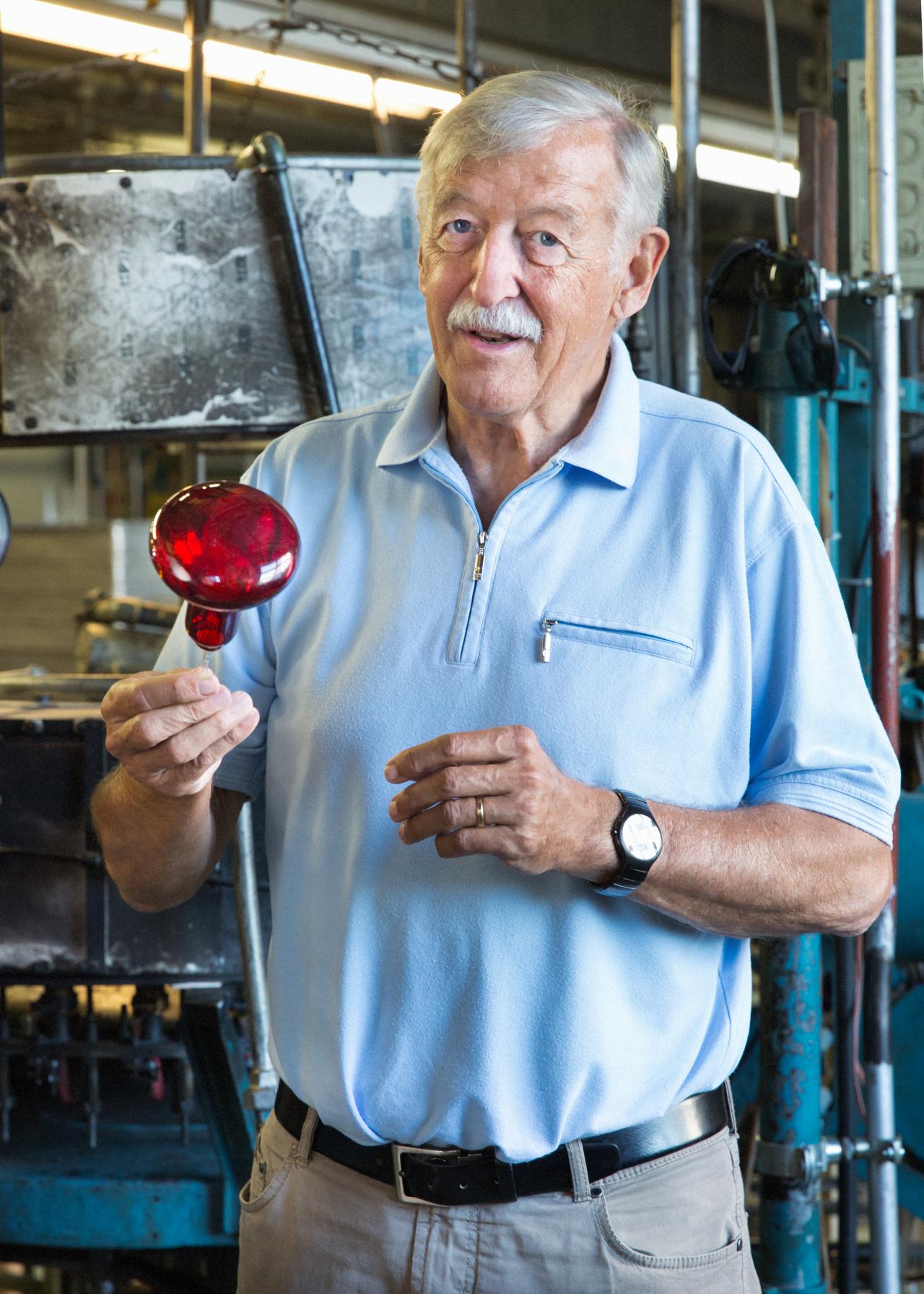 Man holding a red lightbulb